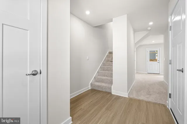 a view of a hallway with wooden floor and entryway