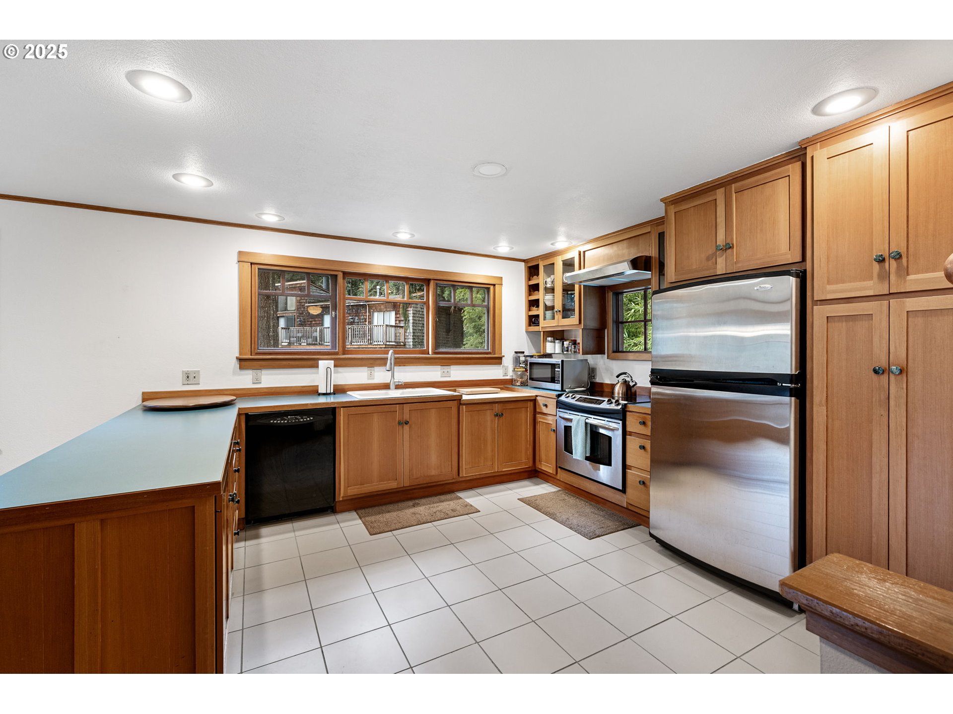 1867 Fircrest Drive Eugene, OR 97403 - Photo 18 of 48 a kitchen with stainless steel appliances a refrigerator sink and stove
