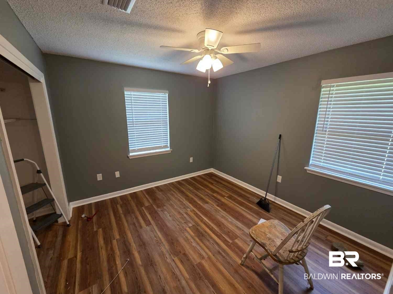 106 West 16th Street Bay Minette, AL 36507 - Photo 19 of 19 Unfurnished bedroom featuring a textured ceiling, wood finished floors, baseboards, ceiling fan, and a closet