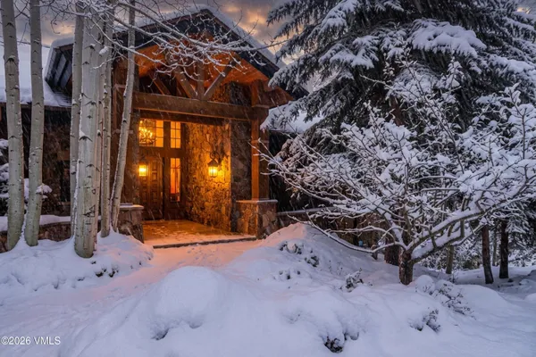 a living room with furniture fireplace and a large window