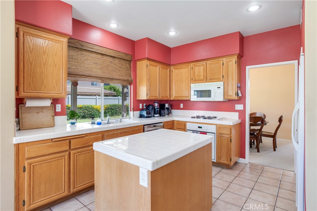 20776 Freeport Drive Riverside, CA 92508 - Photo 18 of 29 a kitchen with a stove a sink a refrigerator and a wooden cabinets