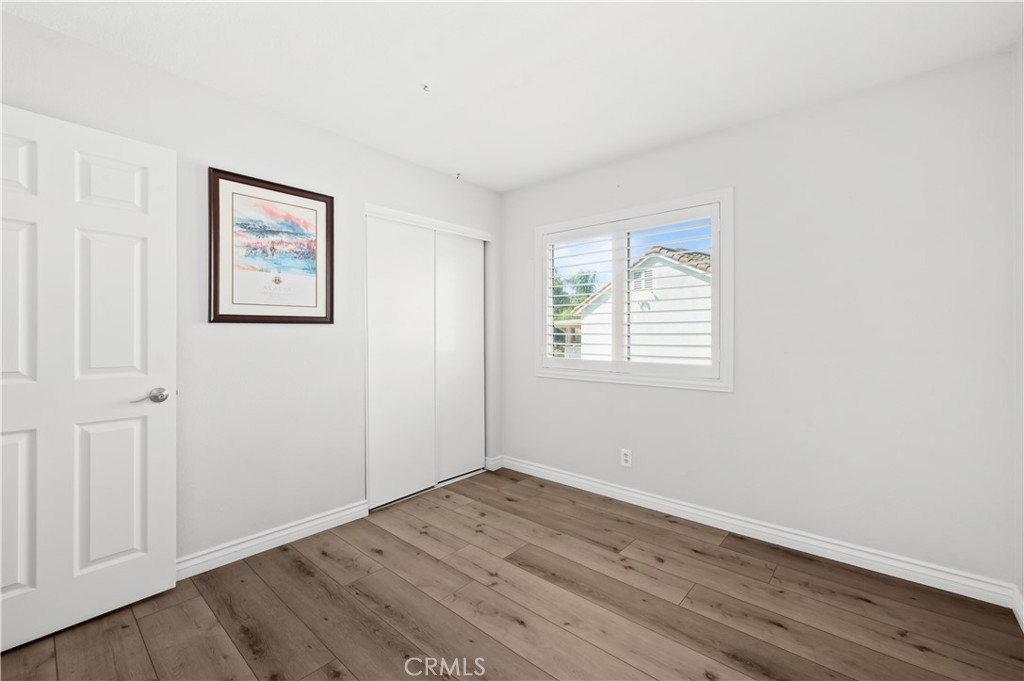19465 Kinnow Lane Riverside, CA 92508 - Photo 32 of 61 an empty room with wooden floor and windows