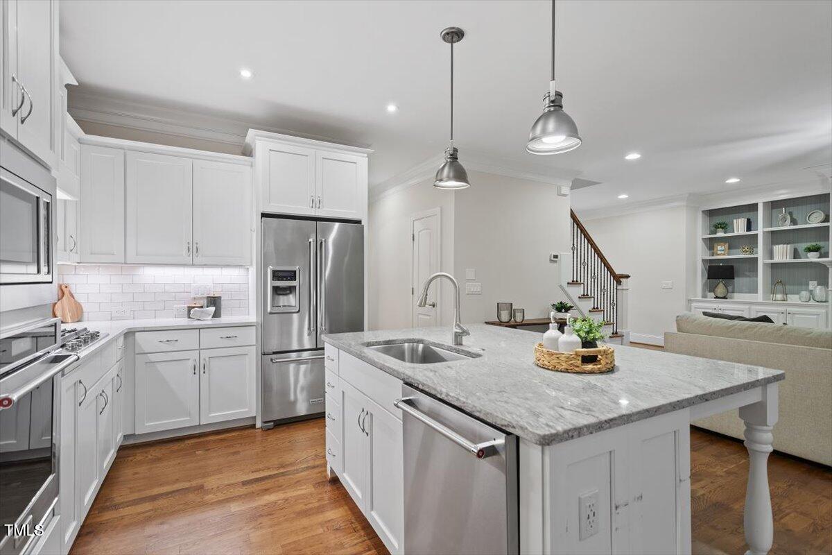 715 Kimbrough Street Raleigh, NC 27608 - Photo 13 of 42 a kitchen with stainless steel appliances granite countertop a sink a stove and refrigerator