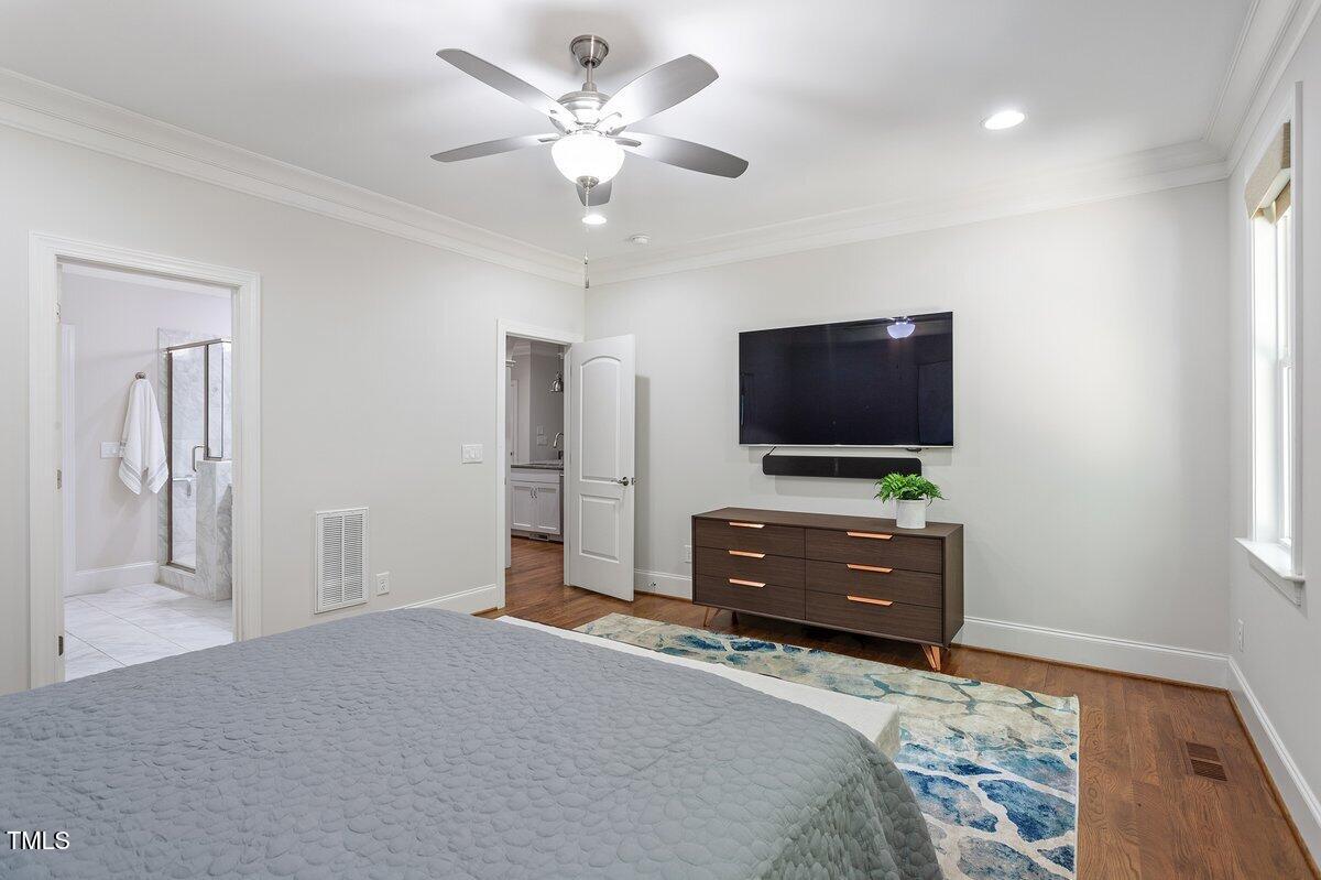 715 Kimbrough Street Raleigh, NC 27608 - Photo 22 of 42 a bedroom with a bed and a flat screen tv