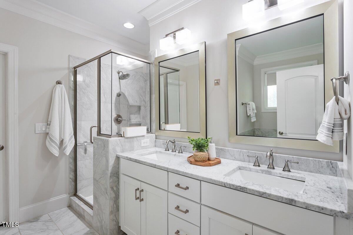 715 Kimbrough Street Raleigh, NC 27608 - Photo 23 of 42 a bathroom with double vanity sinks and a mirror