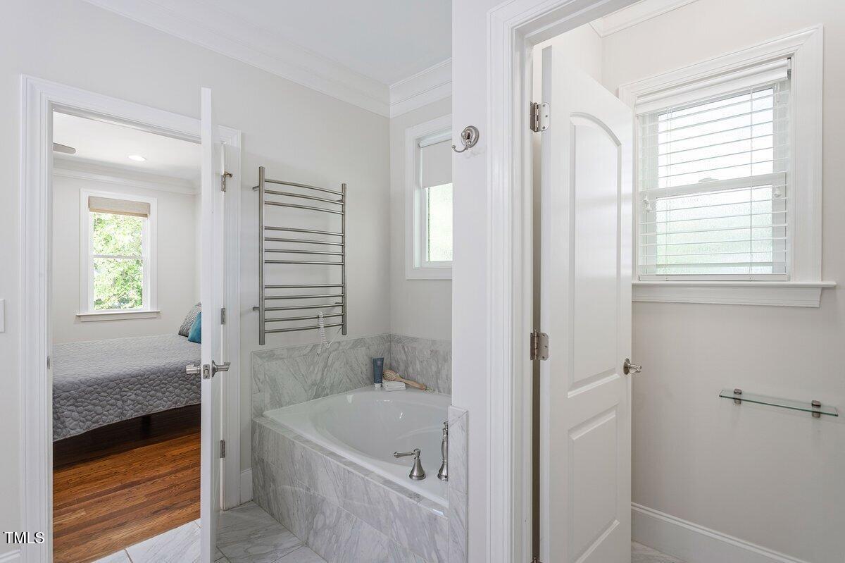 715 Kimbrough Street Raleigh, NC 27608 - Photo 24 of 42 a bathroom with a tub shower and sink