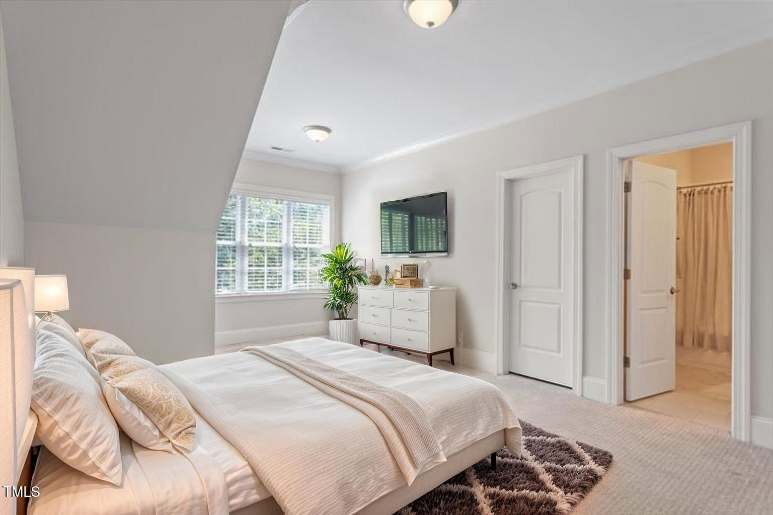 715 Kimbrough Street Raleigh, NC 27608 - Photo 25 of 42 a bedroom with a bed and a window