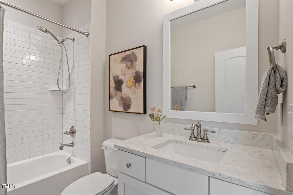 715 Kimbrough Street Raleigh, NC 27608 - Photo 29 of 42 a bathroom with a granite countertop sink toilet and shower