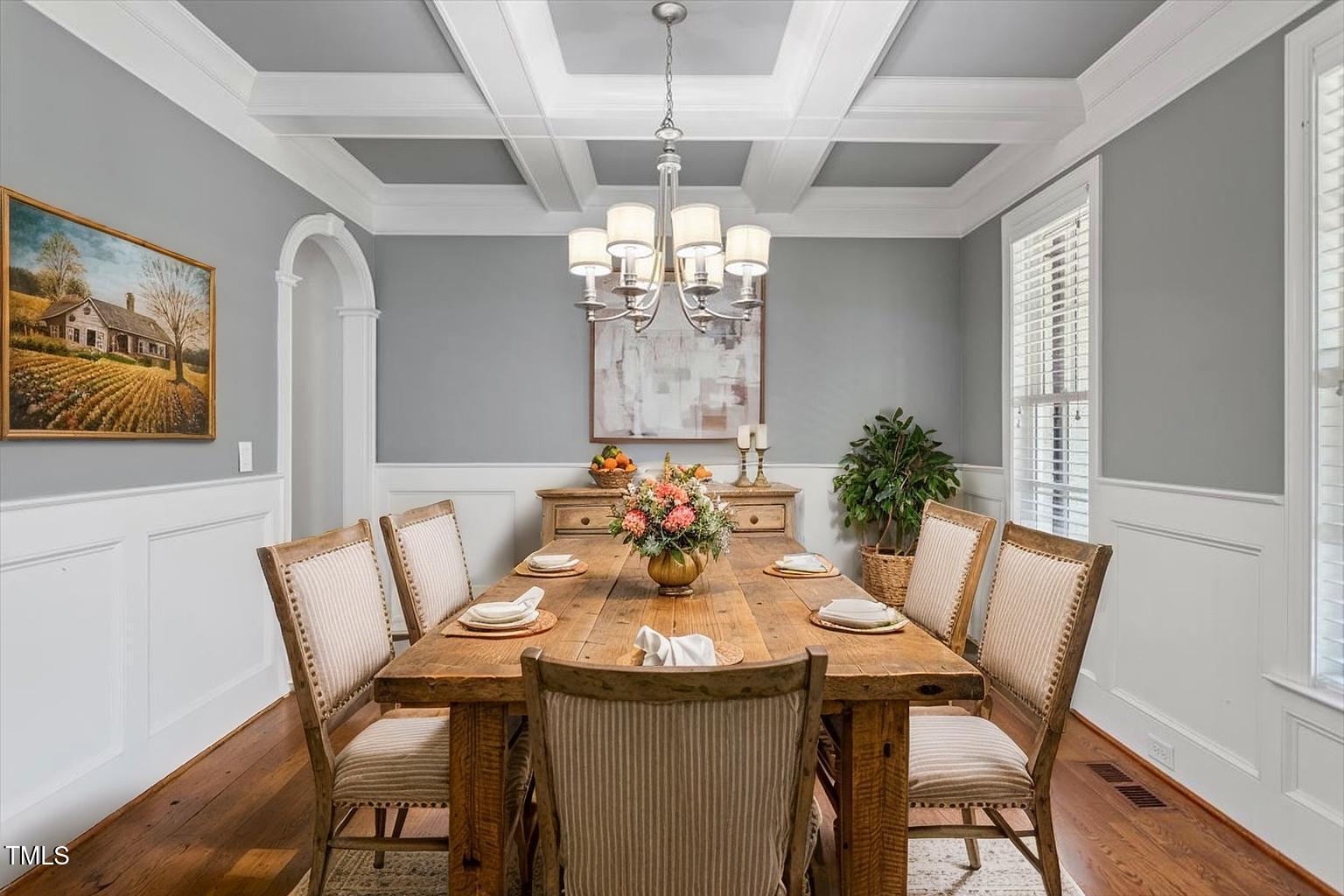 715 Kimbrough Street Raleigh, NC 27608 - Photo 4 of 42 a view of a dining room with furniture a chandelier and wooden floor