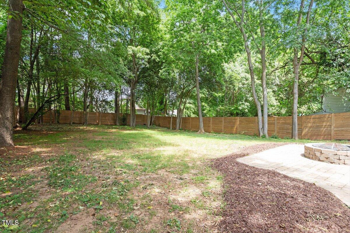 715 Kimbrough Street Raleigh, NC 27608 - Photo 42 of 42 a backyard of a house with lots of green space