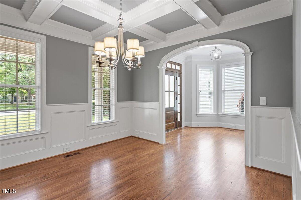 715 Kimbrough Street Raleigh, NC 27608 - Photo 7 of 42 an empty room with wooden floor fan and windows