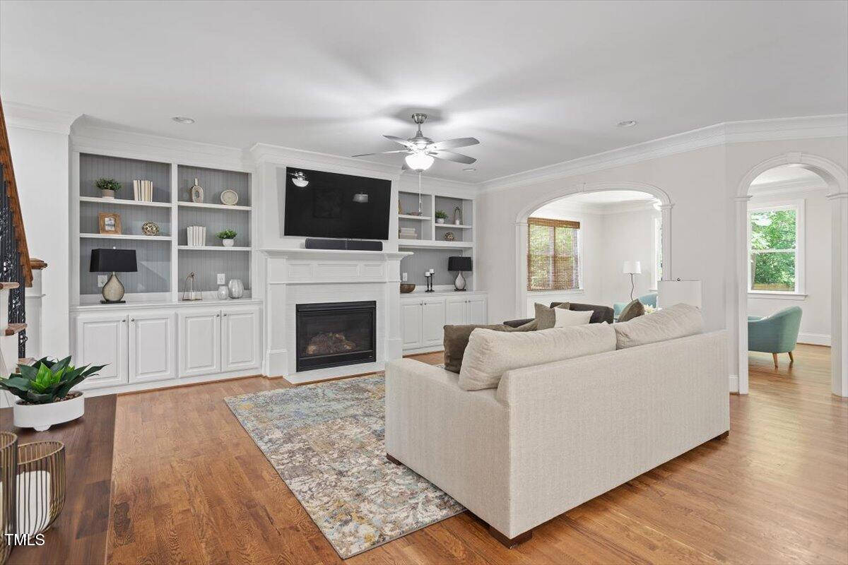 715 Kimbrough Street Raleigh, NC 27608 - Photo 9 of 42 a living room with furniture a flat screen tv and a fireplace