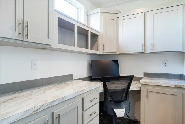 a view of a dining room with furniture and a window