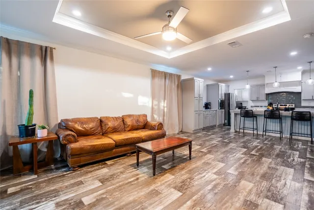a living room with furniture and kitchen view