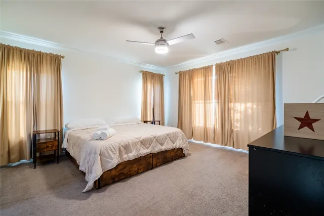 a spacious bedroom with a bed and a window