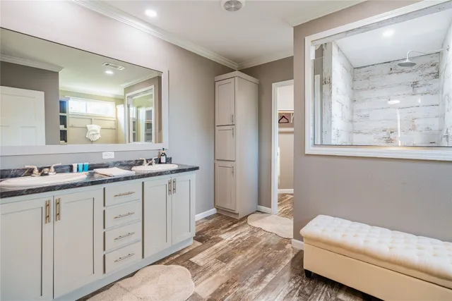 a spacious bathroom with double vanity and a mirror