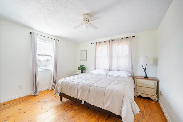 a bedroom with a bed dresser and a window