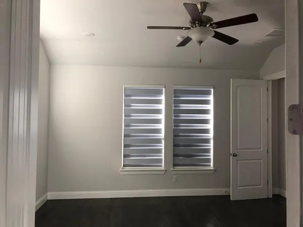 a view of a livingroom with a ceiling fan and a window