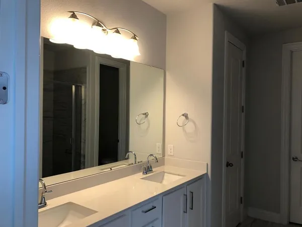 a bathroom with a sink and mirror