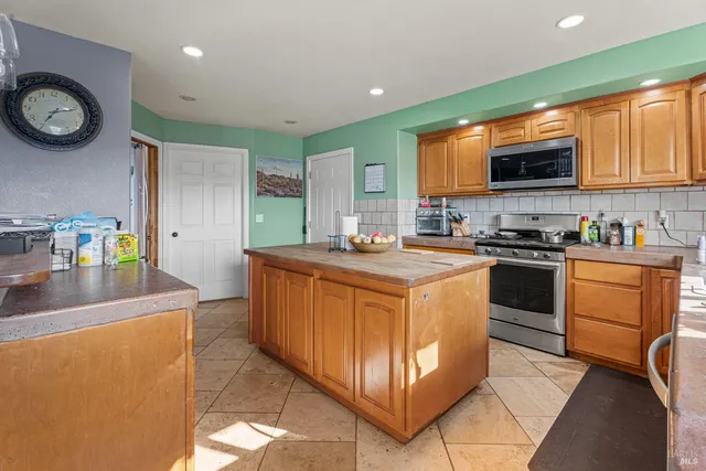 a kitchen with a sink a stove cabinets and a counter top space