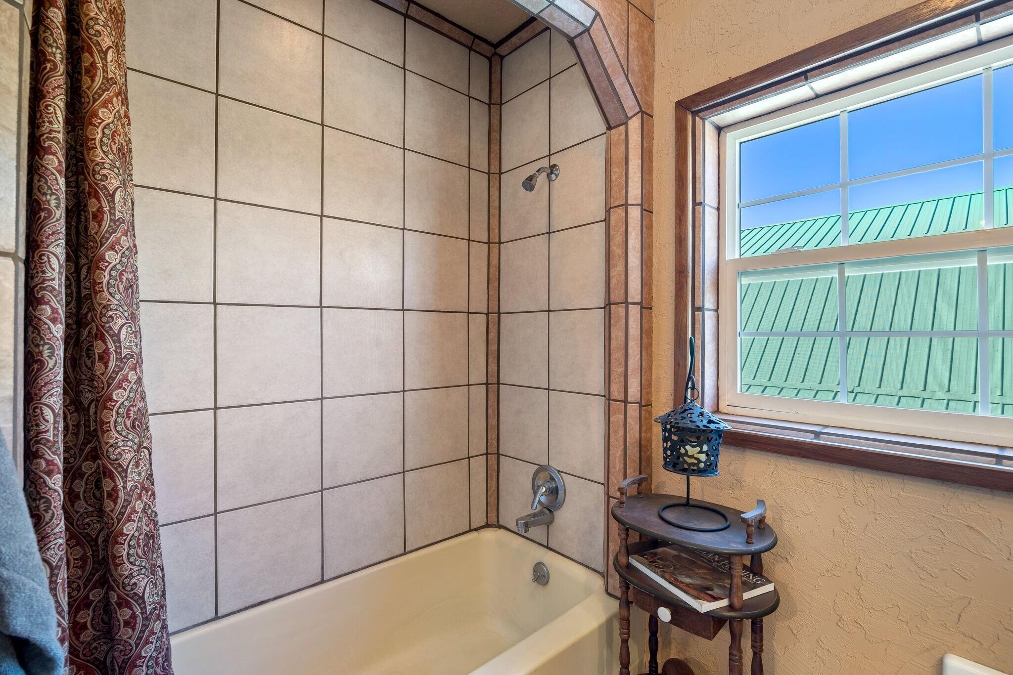 624 Baker Ranch Road Young, AZ 85554 - Photo 27 of 116 a bathroom with a bathtub and next to a window
