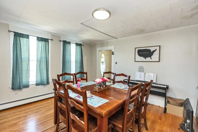 a view of a dining room with furniture and wooden floor