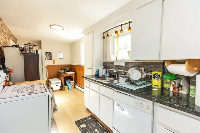 a kitchen with a sink stove and cabinets