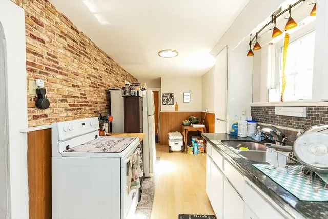 a kitchen that has a stove a sink and a refrigerator