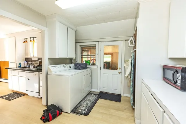 a room with a white cabinets and white appliances