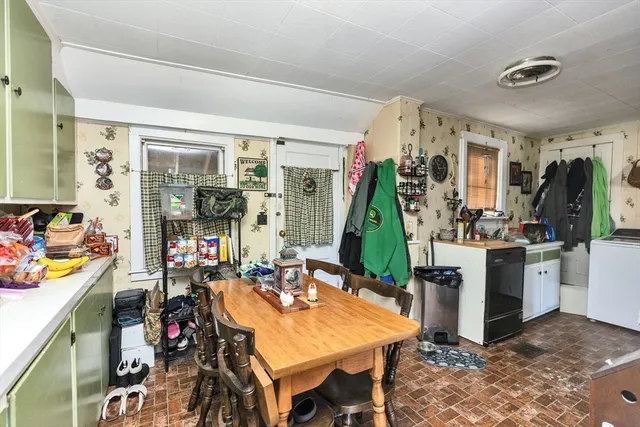 a view of a dining room with furniture and a floor to ceiling window