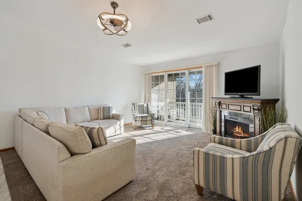 a living room with furniture a fireplace and a flat screen tv