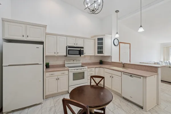 a kitchen with appliances a sink and cabinets