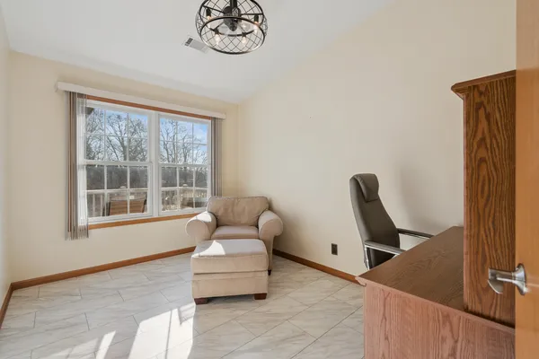 a living room with furniture a window and a flat screen tv