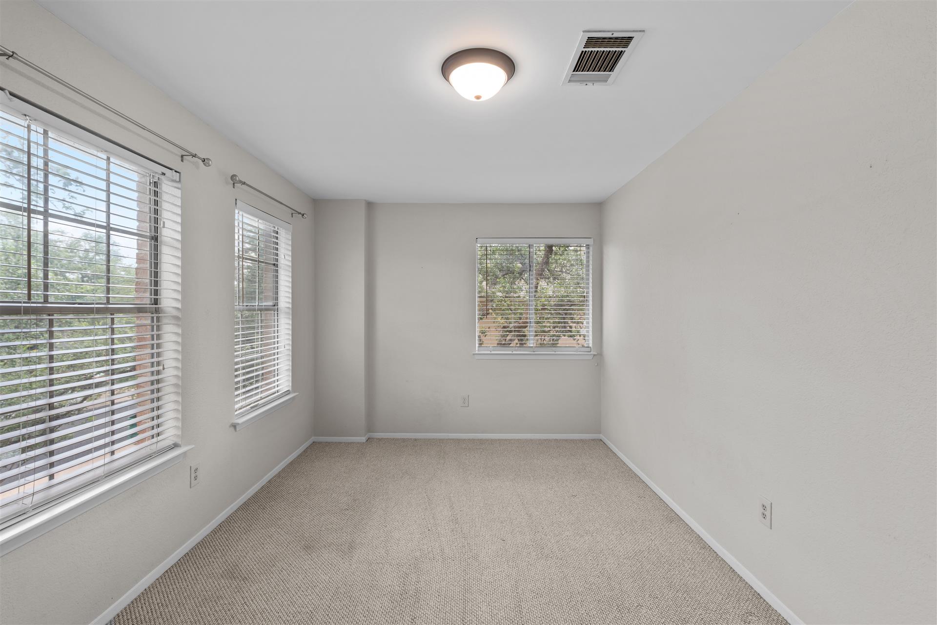 1710 Persimmon Road Cedar Park, TX 78613 - Photo 26 of 33 Secondary bedroom #2 features lot of natural lighting from the multiple windows. Perfect for bedroom, office or studio.