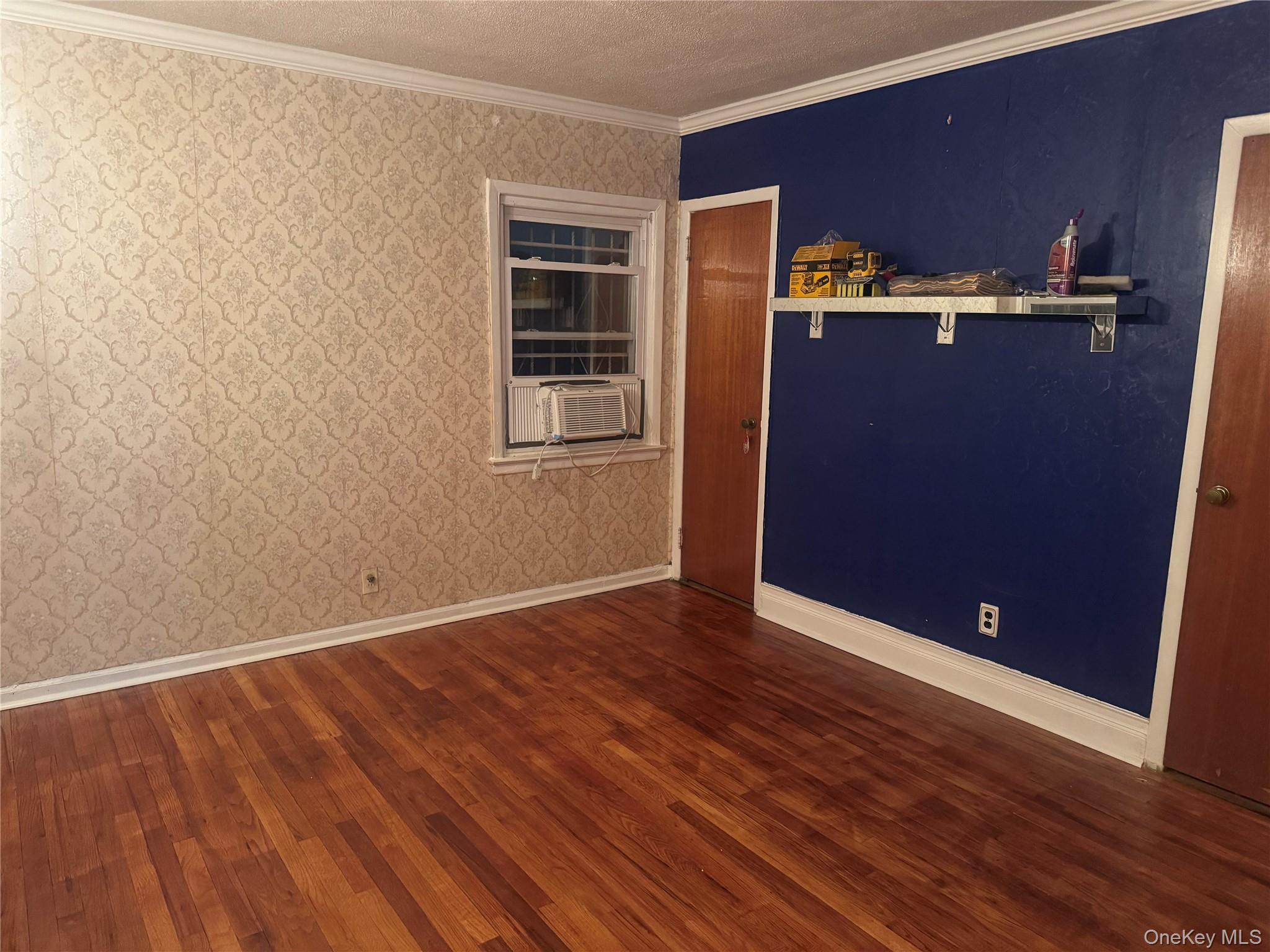 109-11 225th Street, Unit 1 Queens, NY 11429 - Photo 2 of 10 an empty room with wooden floor and windows