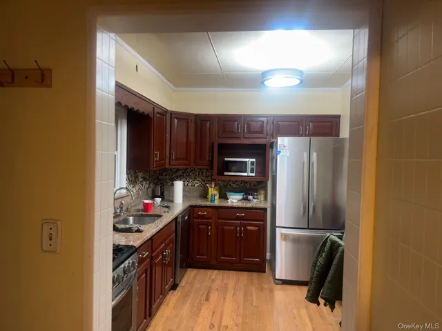 a kitchen with stainless steel appliances granite countertop a refrigerator and a stove top oven