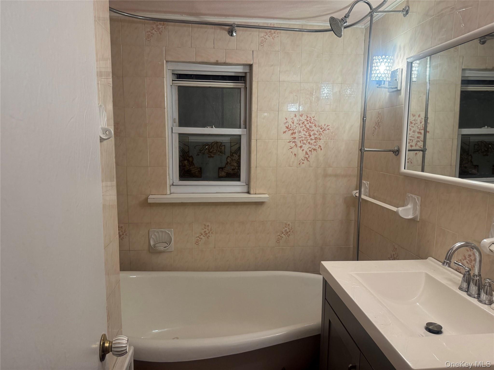 109-11 225th Street, Unit 1 Queens, NY 11429 - Photo 8 of 10 a bathroom with a sink and a mirror