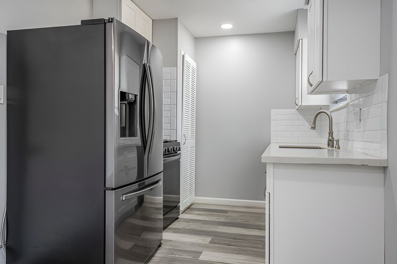 415 Bellmar Lane Friendswood, TX 77546 - Photo 12 of 34 a kitchen with a refrigerator and a sink