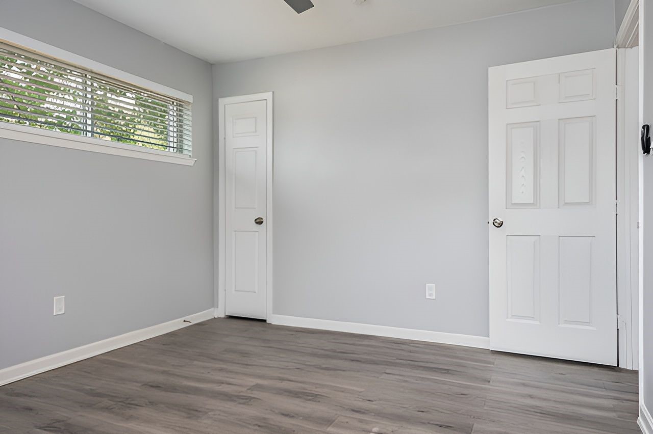 415 Bellmar Lane Friendswood, TX 77546 - Photo 21 of 34 a view of an empty room with wooden floor and a window