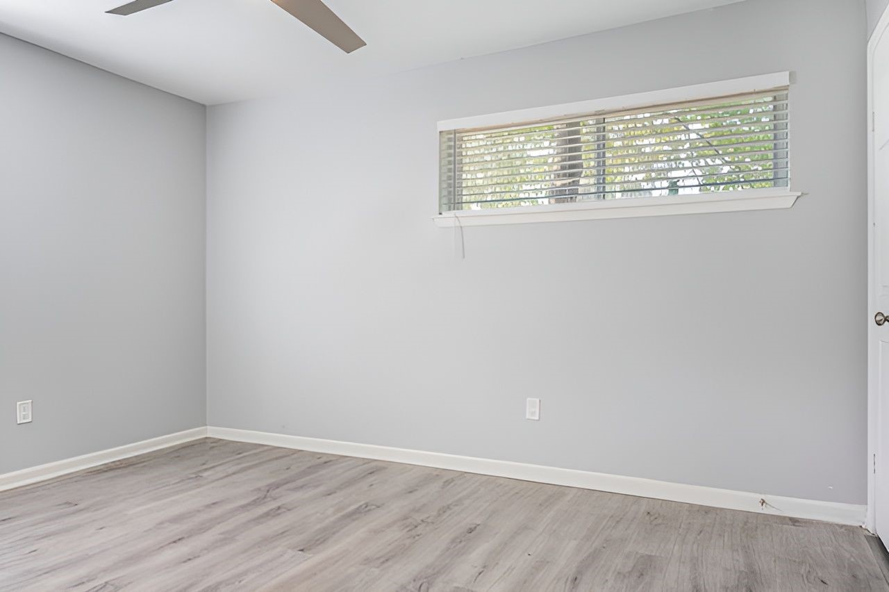 415 Bellmar Lane Friendswood, TX 77546 - Photo 24 of 34 an empty room with wooden floor and windows