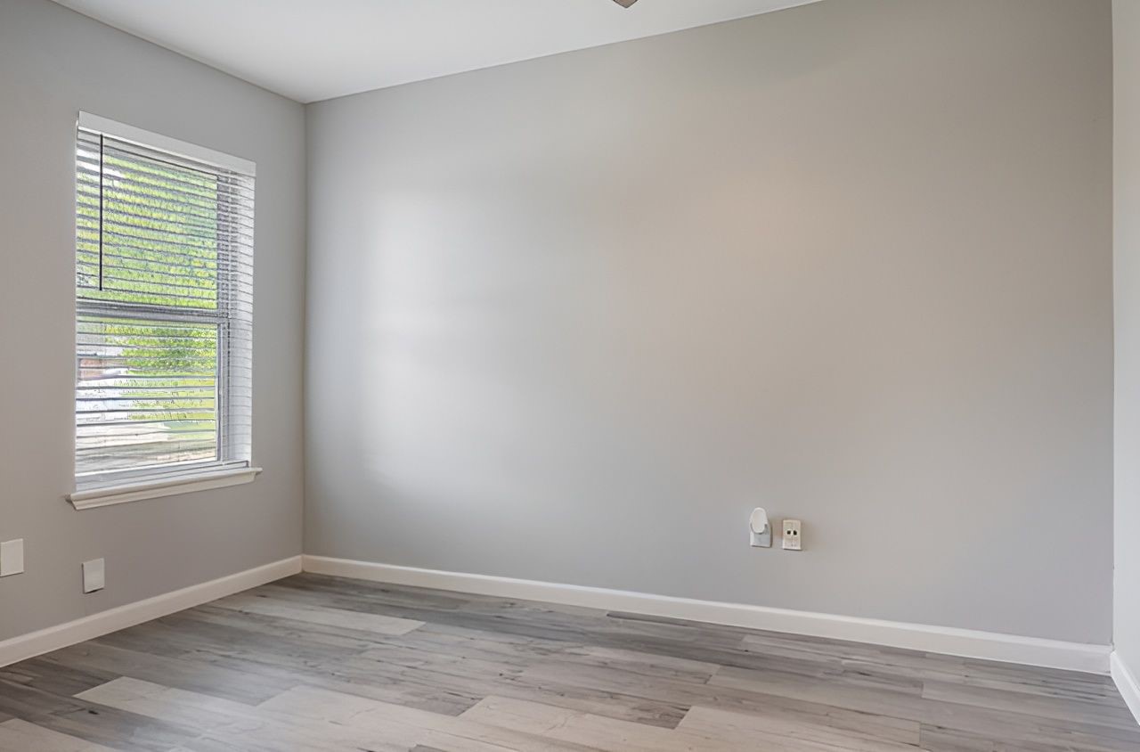 415 Bellmar Lane Friendswood, TX 77546 - Photo 26 of 34 an empty room with wooden floor and windows