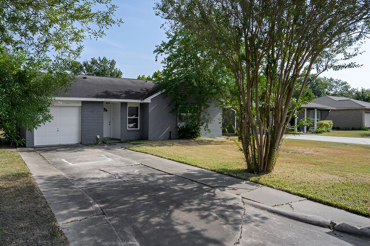 415 Bellmar Lane Friendswood, TX 77546 - Photo 4 of 34 a front view of a house with a yard and garage