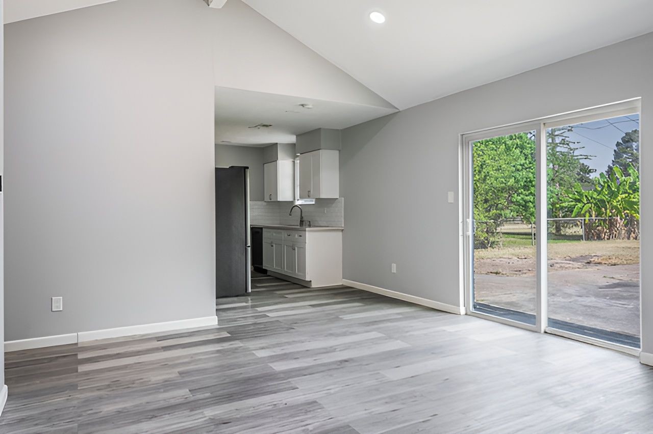 415 Bellmar Lane Friendswood, TX 77546 - Photo 8 of 34 wooden floor in an empty room with a window