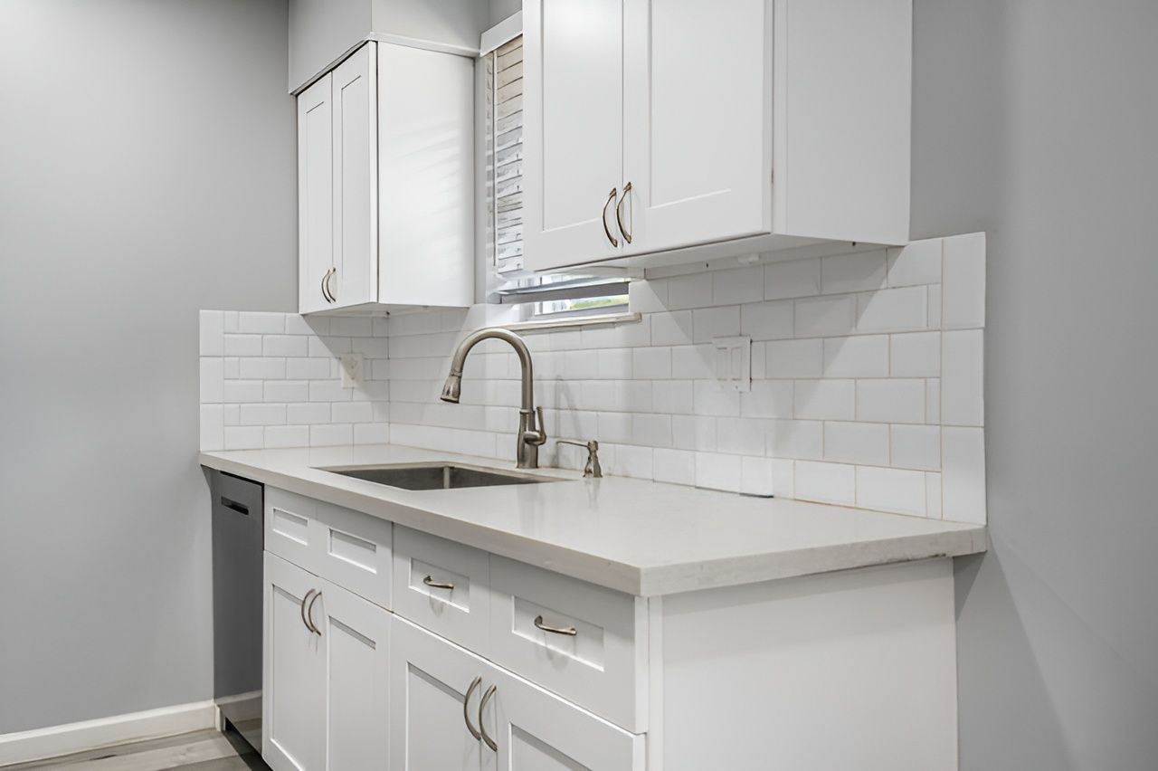 415 Bellmar Lane Friendswood, TX 77546 - Photo 10 of 34 a kitchen with a sink and cabinets