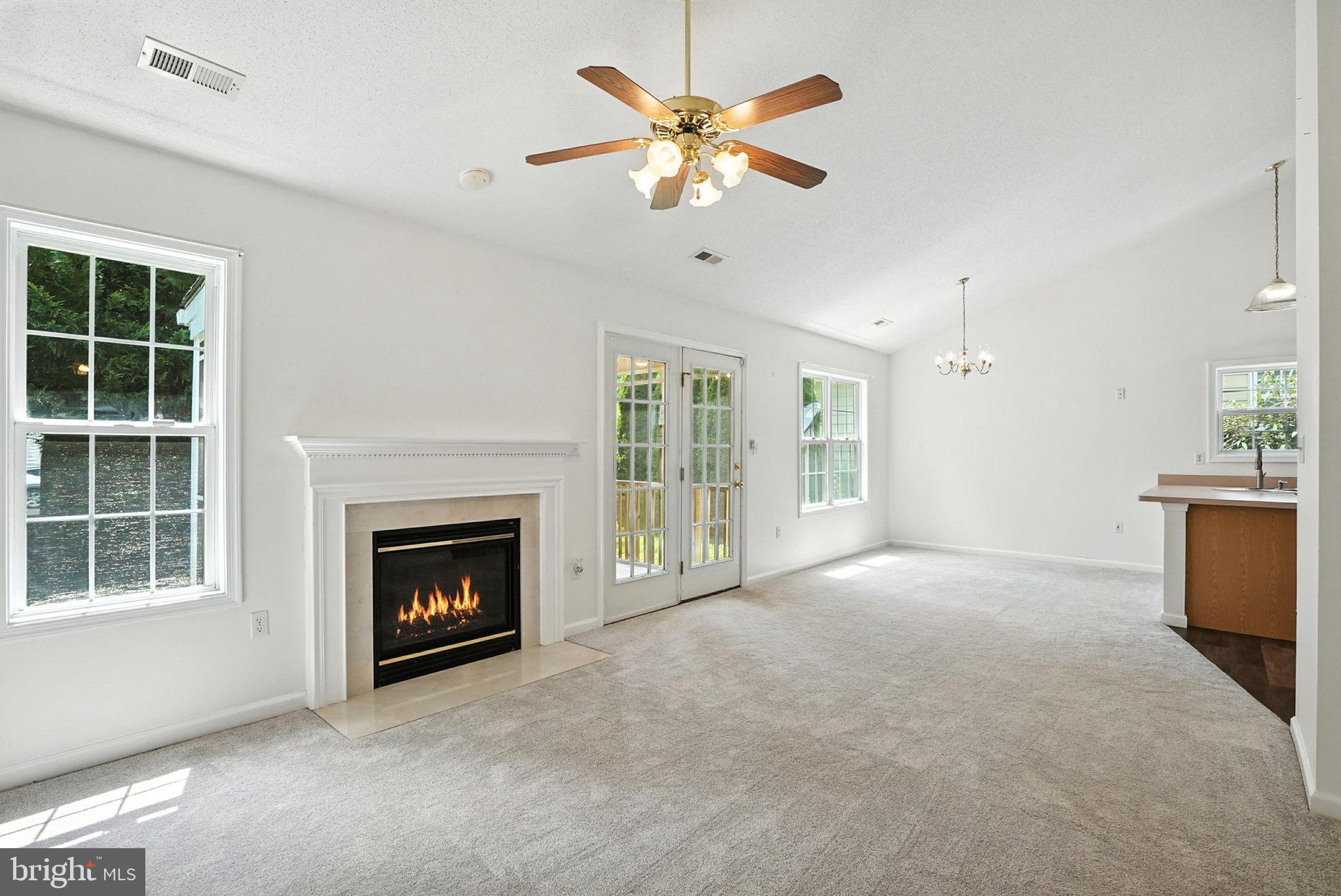 808 Ripplebrook Drive Culpeper, VA 22701 - Photo 12 of 48 a view of an empty room with a fireplace and a ceiling fan