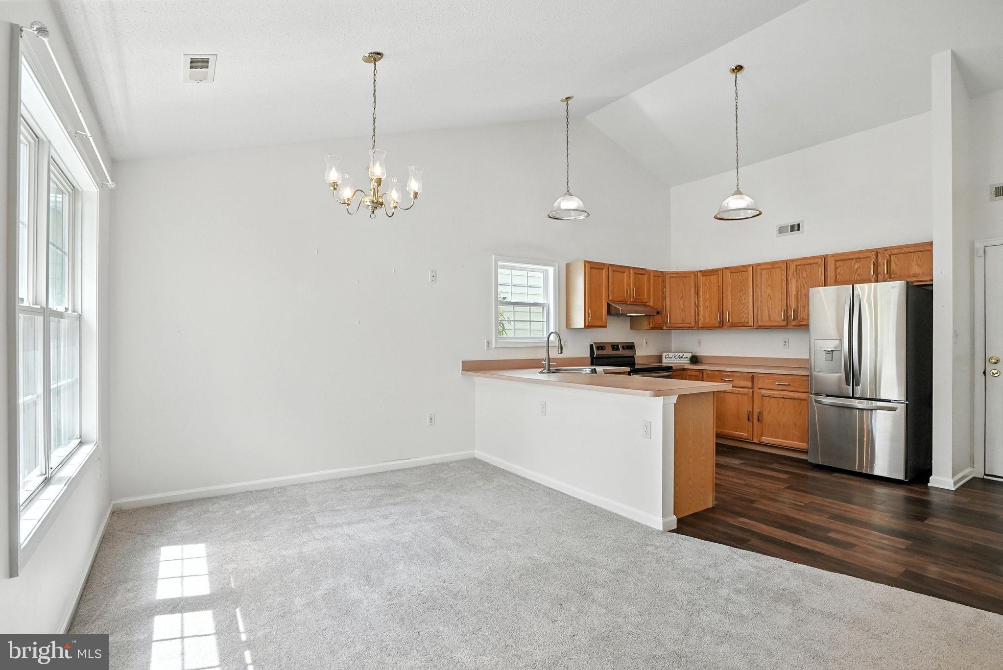 808 Ripplebrook Drive Culpeper, VA 22701 - Photo 14 of 48 a kitchen with kitchen island white cabinets and stainless steel appliances