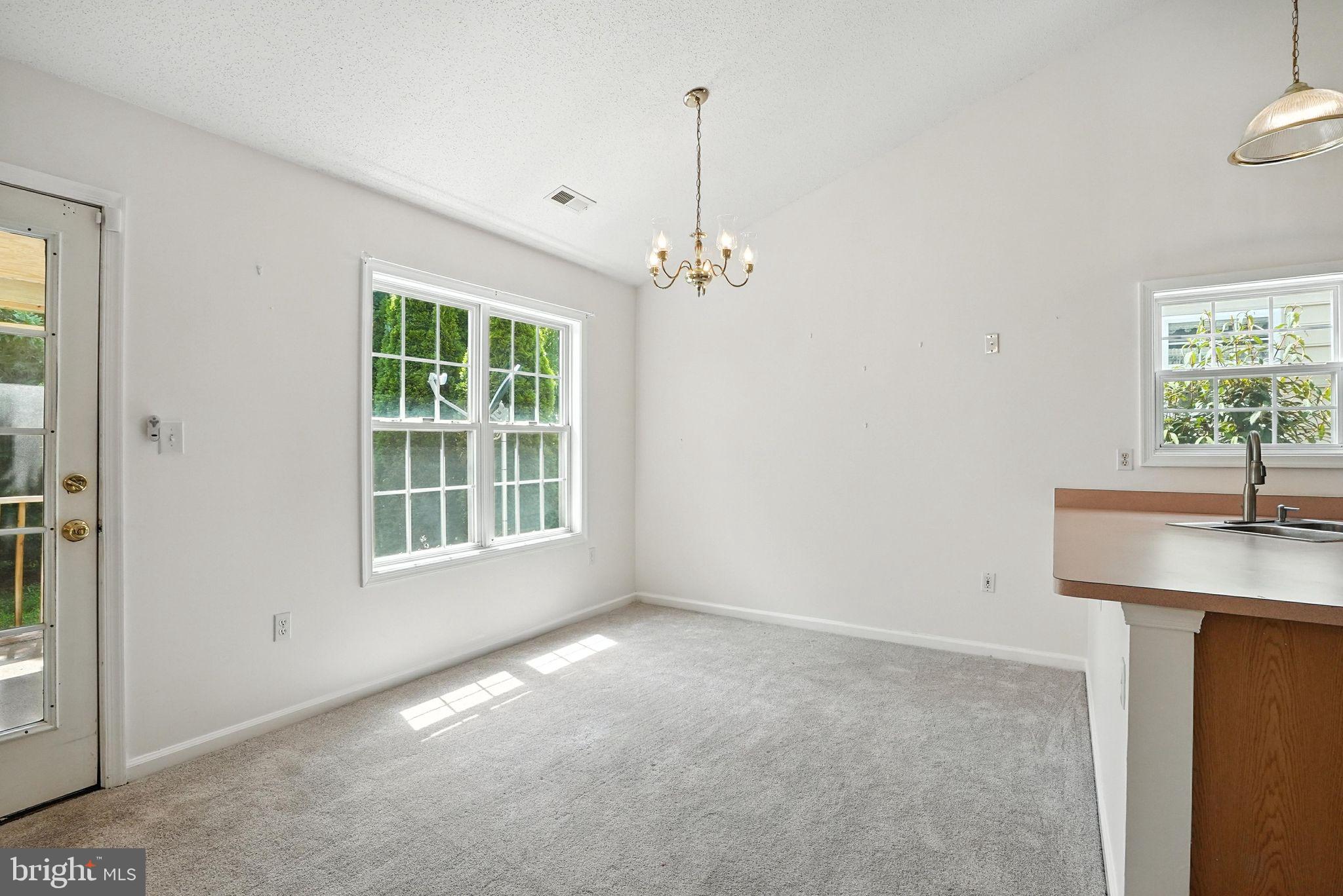808 Ripplebrook Drive Culpeper, VA 22701 - Photo 15 of 48 an empty room with windows and cabinet