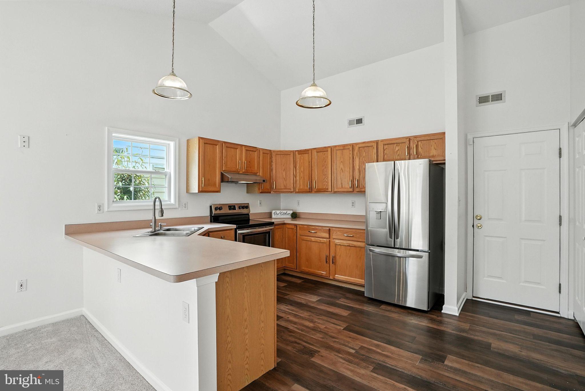 808 Ripplebrook Drive Culpeper, VA 22701 - Photo 18 of 48 a kitchen with stainless steel appliances granite countertop a refrigerator a sink dishwasher a stove and a refrigerator with wooden floor
