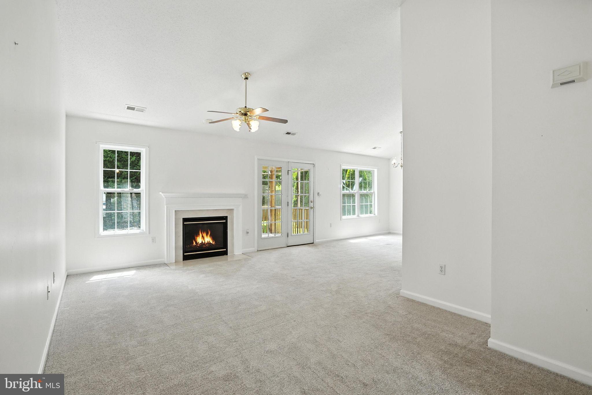 808 Ripplebrook Drive Culpeper, VA 22701 - Photo 10 of 48 an empty room with windows and fireplace
