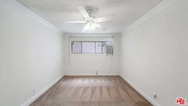 a view of a hallway with a ceiling fan